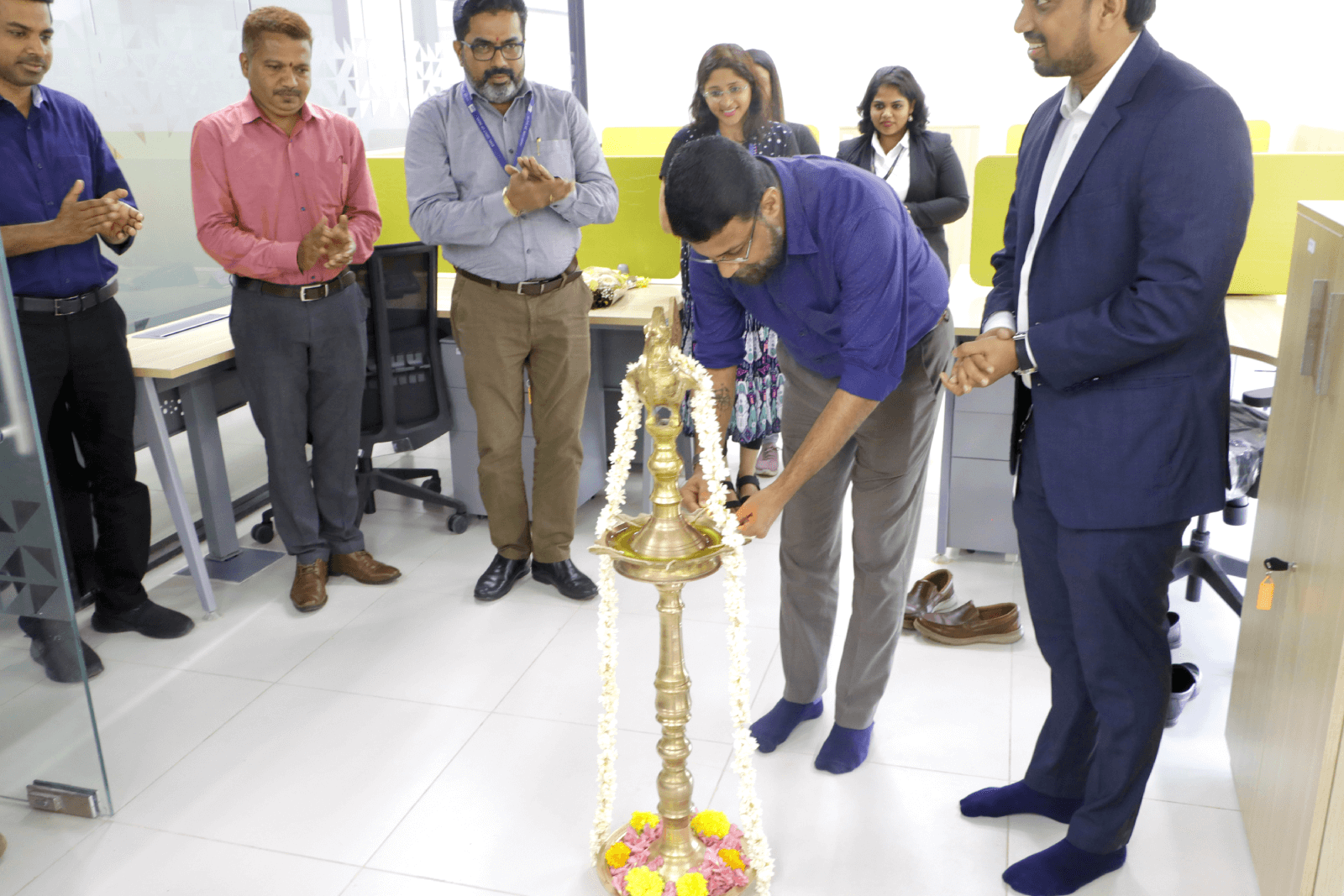 Col Sanjeev Nair (Retd) lighting the ceremonial lamp to inaugurate the new office of NxtGenix Solutions.