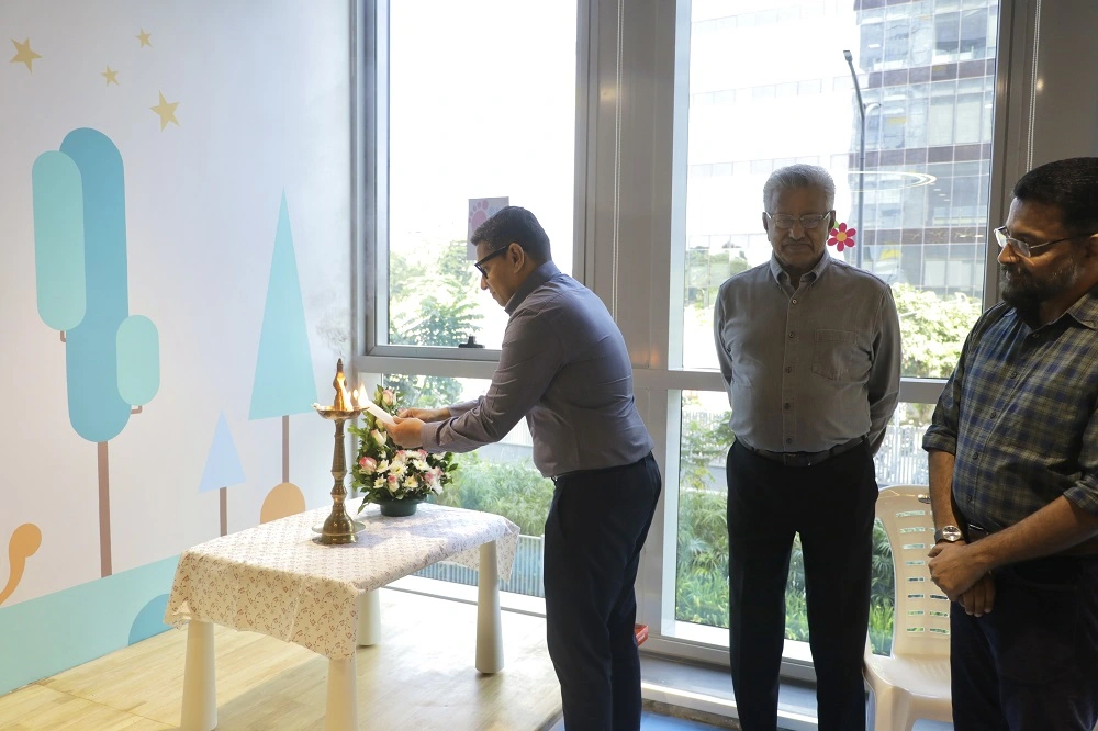 Mr. Johan Jacob P, Director, Global Public School, lighting the ceremonial lamp at the launch of Stepping Stones creche and kindergarten by Global Public School at Technopark Phase III.