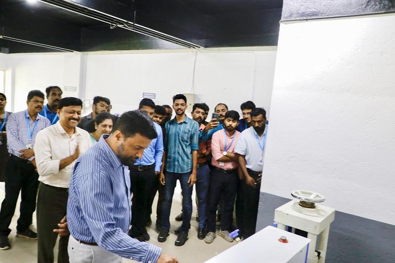 CEO Technopark switching on the equipment at the newly launched engineering lab to formally launch it.